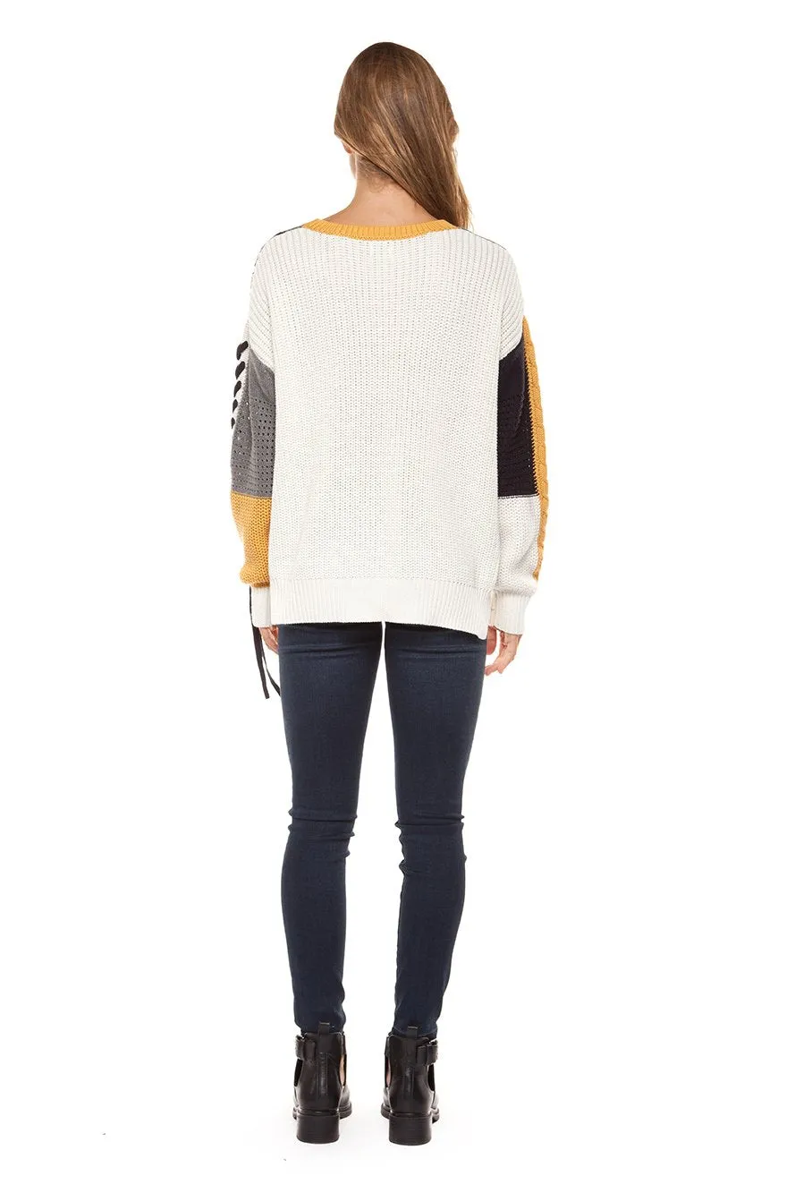 Long sleeve color block cable knit sweater with lace-up trim